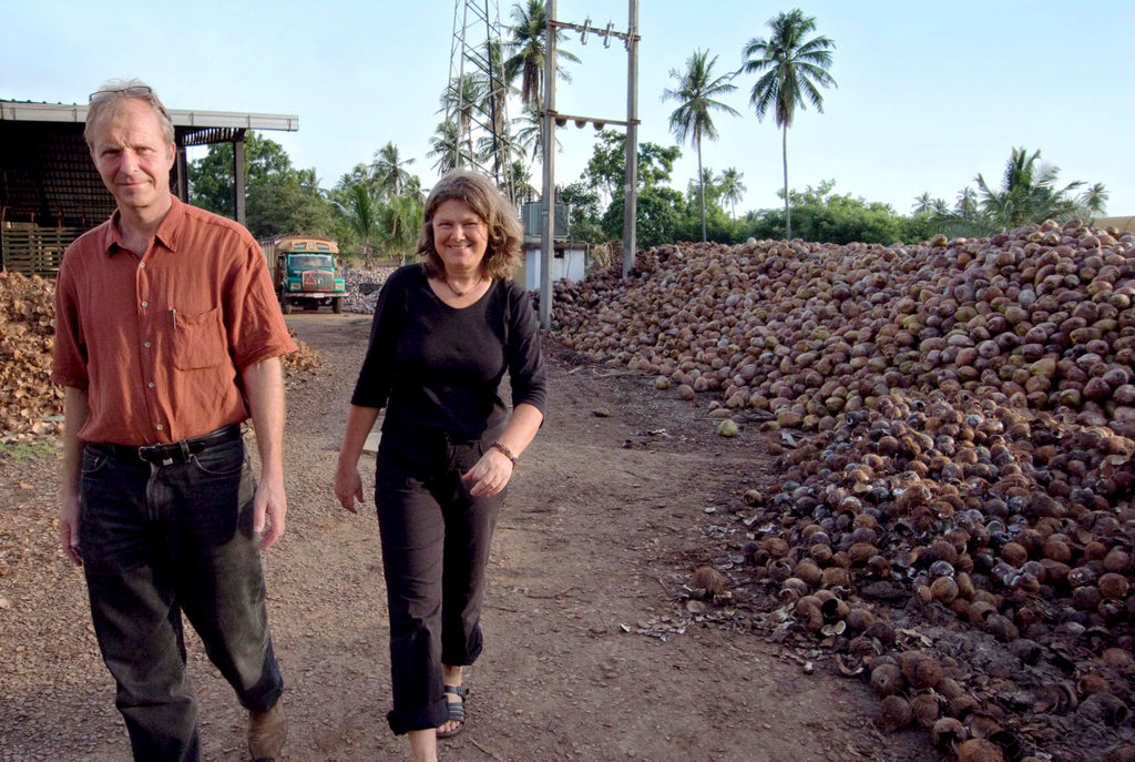 Gero Leson and Christel Dillbohner walking through a coconut processing facility. 