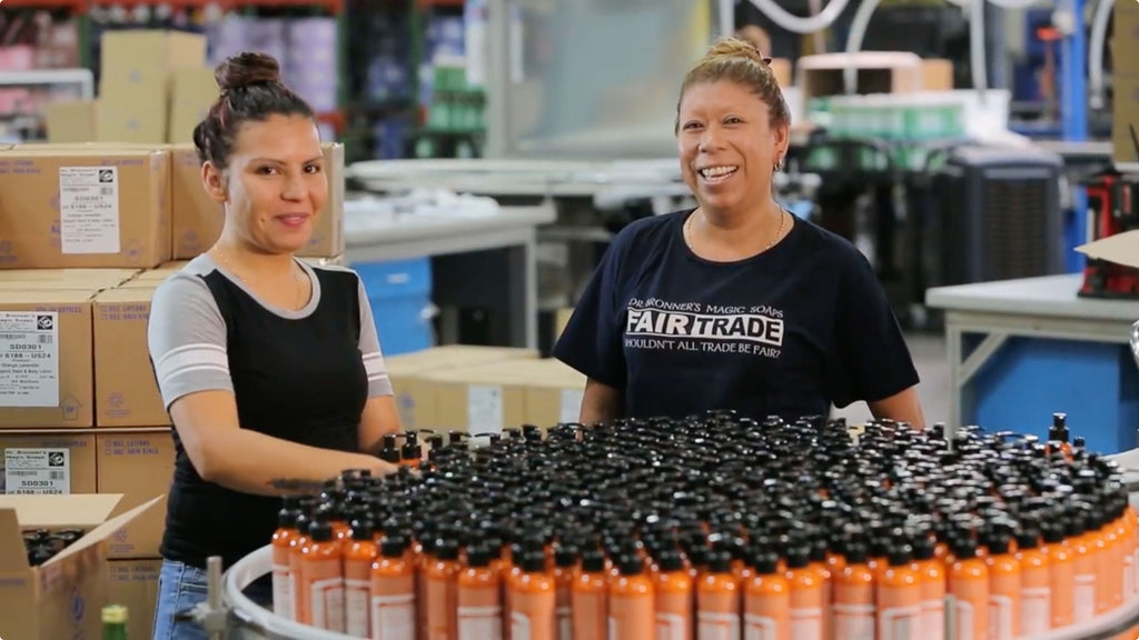 Smiling employees preparing products.
