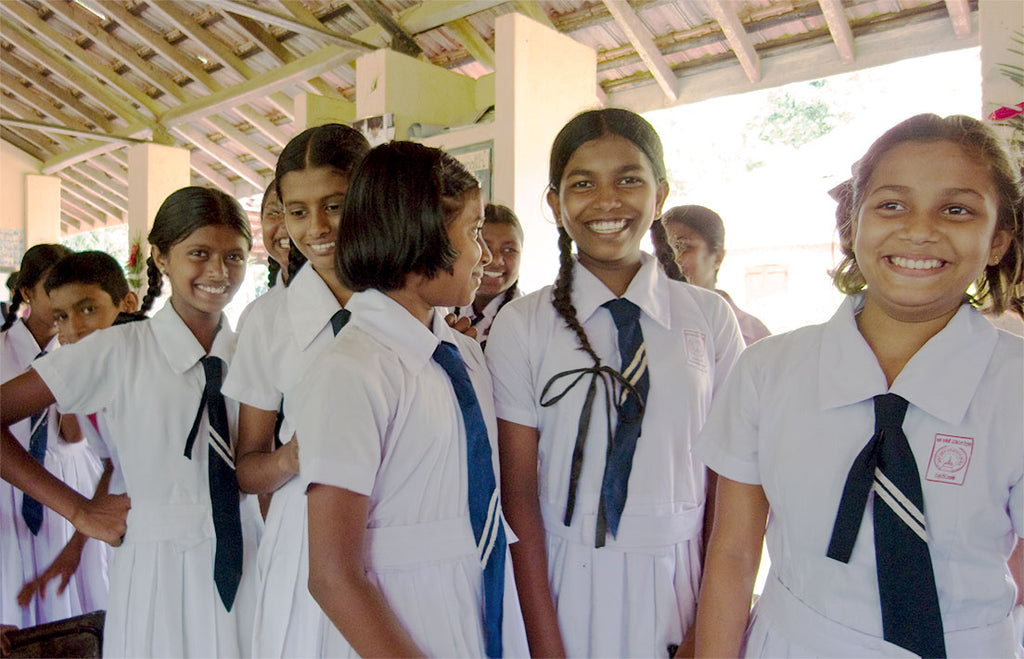 Smiling children in school uniforms.