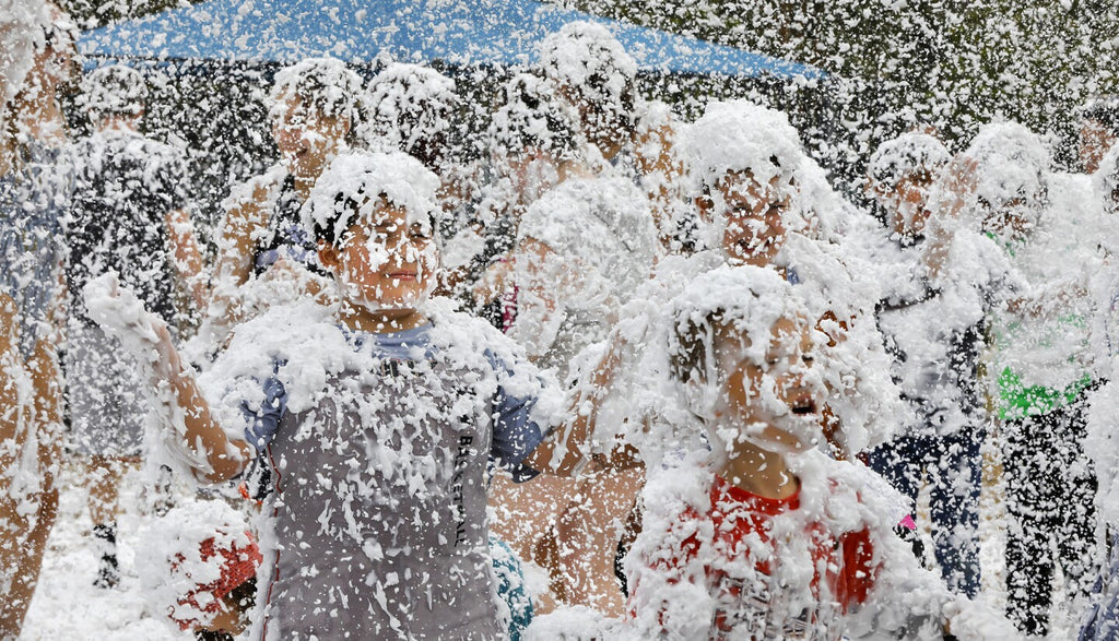 Children playing in a giant mist of foam.