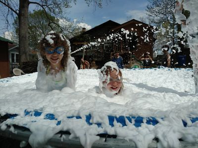 Children wearing goggles playing in foam.